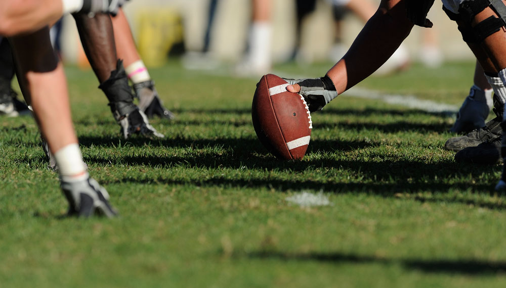 Football players at line of scrimmage