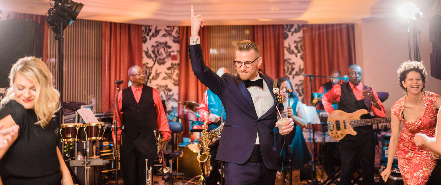 Groom and guest at wedding dancing