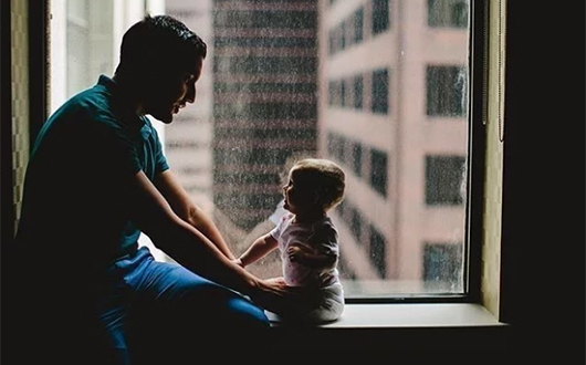 Father and baby in Monaco Baltimore windowsill